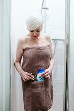 Load image into Gallery viewer, Maisy dignity towel with velcro to hold in place and pockets for shower essentials
